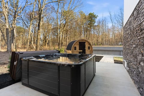 Outdoor hot tub with cedar barrel sauna just steps away — unwind in the woods