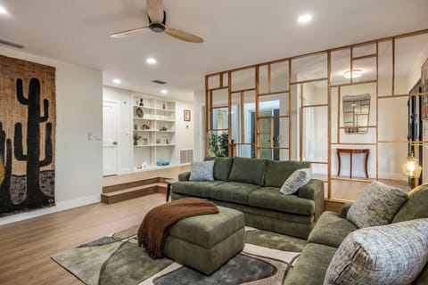 The sunken great room behind the Mondrian wood screen — the house's signature.