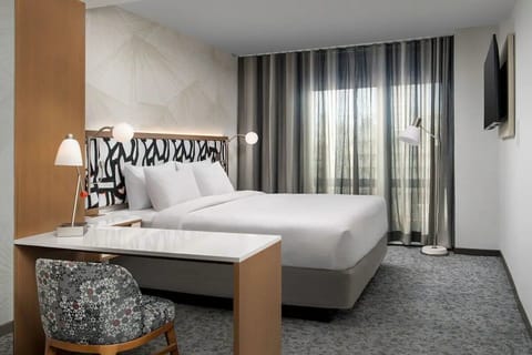 Unwind in a bright, modern room with plush bedding.