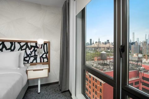 Wake up to skyline views framed by floor-to-ceiling windows.