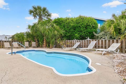 Spacious pool area with lounge seating for soaking up the coastal sun