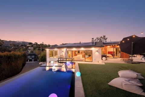 Stunning sunset view over the pool and outdoor lounge, perfect for relaxing evenings