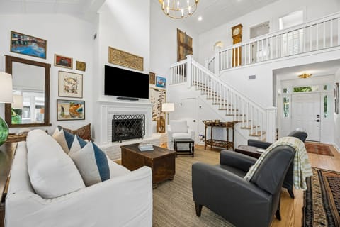 Luxury Living Area Featuring Plush Couch and Chairs, Flat Screen Smart TV, and Gorgeous Decor