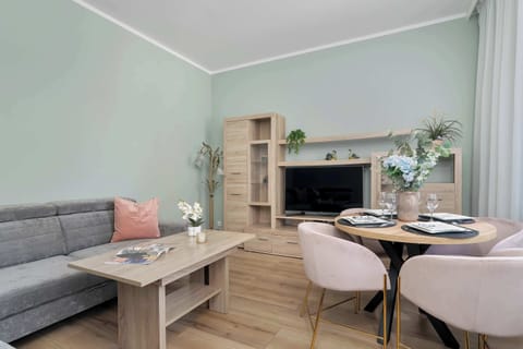A bright living and dining space with a sofa and a table. The layout is practical and ideal for everyday use.