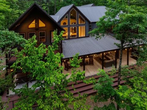 Escape to your private woodland retreat featuring soaring windows, cozy gathering spaces, and unforgettable views.