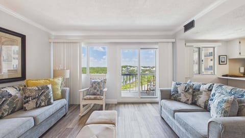Living area with sliding doors out to balcony and holds ample seating