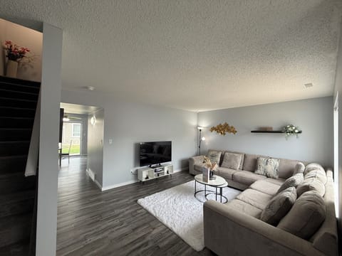 Living room with stairs leading to the 3 bedrooms