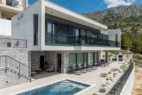 A private courtyard with a swimming pool and sun loungers.