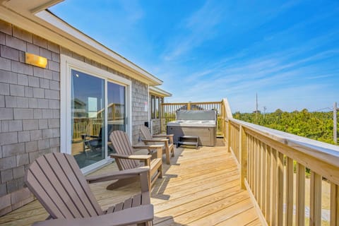 Relax on your private deck with Adirondack chairs and hot tub, perfect for unwinding while enjoying forest views.