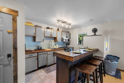 Your bright kitchen features beautiful wood counters, modern appliances, and a cozy island where you can cook and gather.