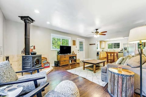 Gather around the wood-burning stove after a day exploring Forestville wineries — your cozy wine country living room awaits