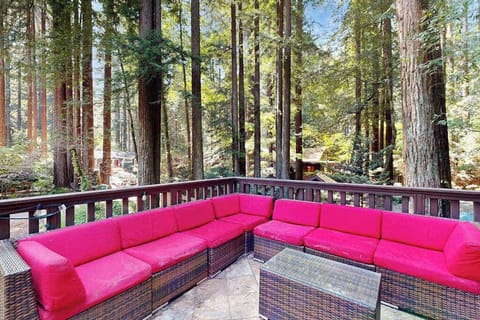 Lounge on your vibrant outdoor sectional as sunlight filters through ancient redwoods — mornings here feel like your own private forest sanctuary near the Russian River.