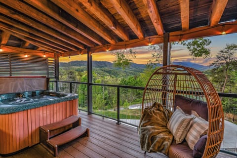 Soak in the hot tub and unwind with stunning sunset mountain views