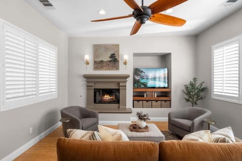 Living Room: A cozy, inviting space with a plush sofa, a fireplace, and a sleek TV setup, perfect for relaxing or entertaining.