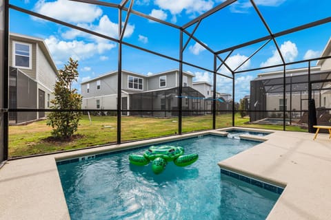 Dive into your private screened pool with spillover spa-sunny patio vibes and a playful float for family fun.