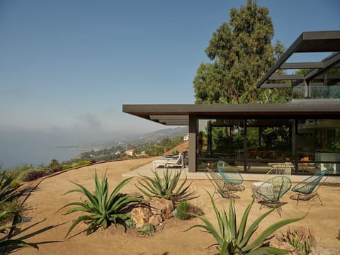 Private terrace with panoramic ocean and mountain views — your outdoor living room in Malibu.