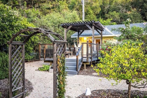Step through your private vine-draped arbor into a storybook Cloverdale cottage tucked among lush gardens and towering trees