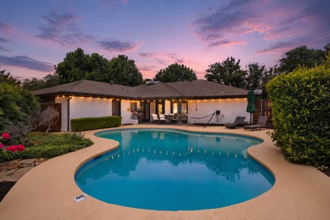 Backyard oasis at golden hour—sparkling pool, cozy string lights, and lounge-ready vibes for the perfect evening unwind.