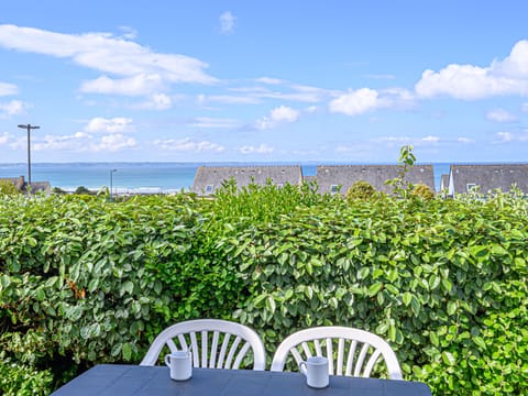 Terrace with a table and chairs — sea air, sunshine, and views over the bay all day long