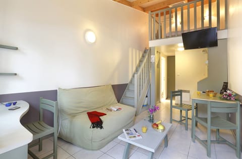 Living area with double sofa bed and two single beds — plenty of space for up to 6 guests