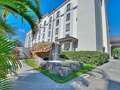 Start your stay beside lush landscaping and a calming waterfall.