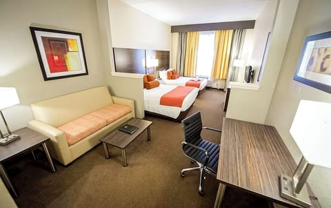 Unwind in a bright suite with cozy bed and workspace.