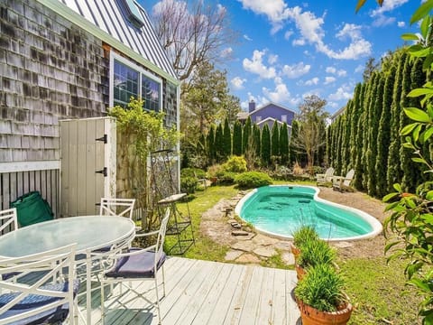 Pool with sun loungers and green surround — all yours after a morning on the beach
