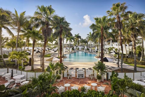 Palm trees frame the heated outdoor pool — pull up a lounge chair and spend the afternoon in the Florida sun