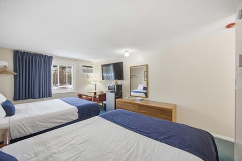Unwind in one of Suite 215’s plush queen beds after a day on the town​