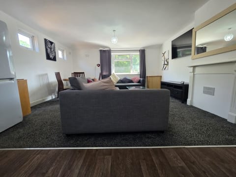 Designed for flexibility and comfort, this versatile space offers a kitchenette for self-catering, a dining area for meals or workspace, a 55" Smart TV for downtime, and a sofa bed that provides additional sleeping for 2 – ideal for groups or visiting colleagues.