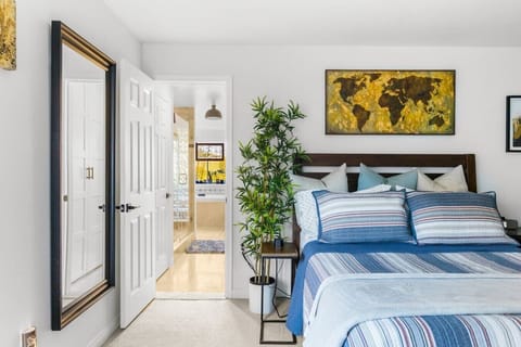 Clean lines, bold art, and a comfortable king bed — the primary suite is designed for a good night`s sleep and a great morning.