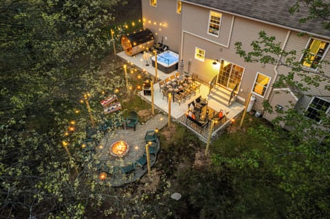 Private outdoor oasis featuring a hot tub, cedar barrel sauna, fire pit, and outdoor dining