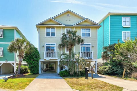 Charming coastal home with tropical landscaping and covered parking in a vibrant beachside neighborhood.