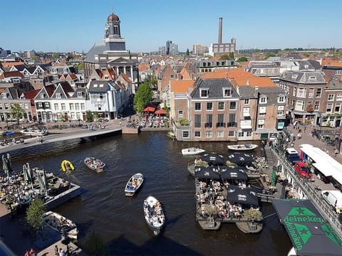 Sip and people-watch over bustling waterside terraces and boats.