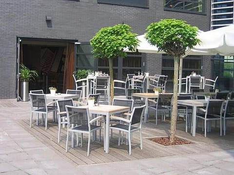Unwind outdoors with drinks and conversation under shady trees.