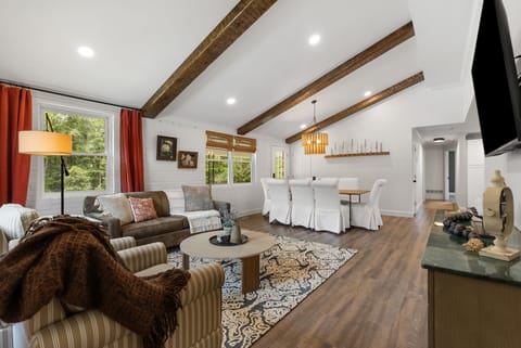 Our spacious and comfortable living room, adjacent to the dining room and kitchen. Seating for 5+ adults, TV, and games!