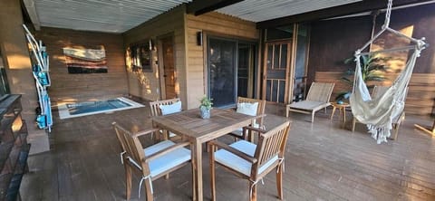 Large screened lanai with dining table, loungers, hammock chair and plunge pool