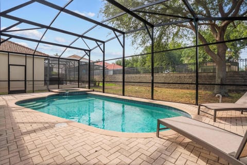 Private screened pool area with spa and lounge chairs for relaxing outdoor enjoyment.