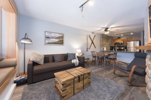 Whistler themed living room with queen sofa bed, wood floors and comfortable seating