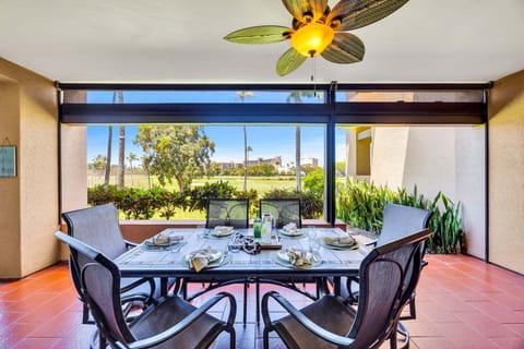 Enjoy al fresco dining with a beautifully arranged table overlooking lush greenery and open space.