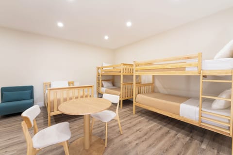 Gather your group in this bright, versatile bunk room where everyone can share stories late into the night. Fresh linens and modern wood furnishings make group stays comfortable and fun.