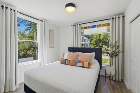 Unwind in a comfortable queen bed with plush, cozy pillows.
