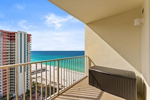 Private balcony with stunning Gulf views, beach breezes, and a storage container stocked with beach gear, including chairs, an umbrella, toys, and a wagon for guest use.