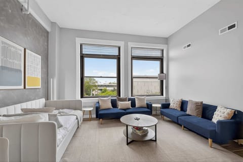 Bright living room w/ cozy seating, large windows & a calm open layout for relaxing afternoons
