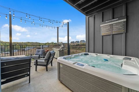 Unwind in your bubbling hot tub on this scenic balcony, where twinkling string lights create perfect ambiance for evening soaks.