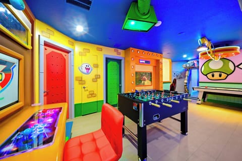 Step into a vibrant game room adorned with playful, colorful murals that bring energy to every corner. Enjoy hours of fun around the foosball table, illuminated by cheerful lighting that enhances the lively atmosphere.