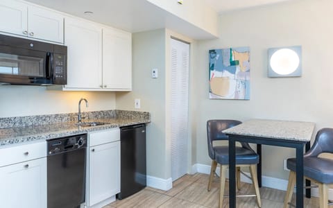Cook effortlessly with granite counters and full kitchenette essentials.