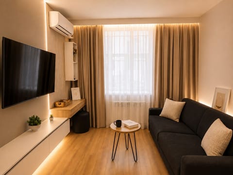 Stylish contemporary living area featuring a comfortable sofa, smart TV, 