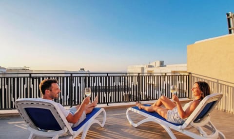 Private rooftop terrace with sunbeds and city views