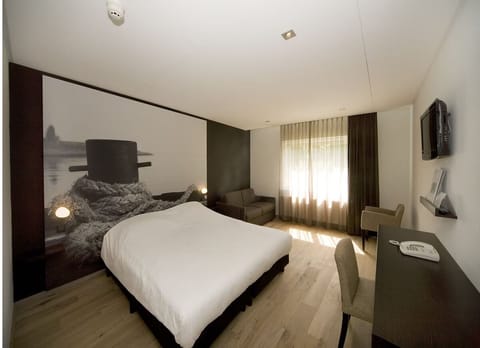 Settle into a peaceful night beside cozy seating and soft light.